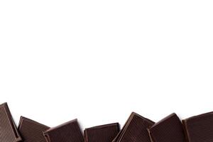 Piece of dark chocolate isolated on white background photo