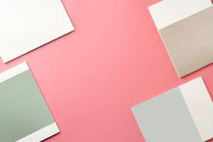A Collection of Blank Papers Stacked on a Pink Surface for Creative Projects photo