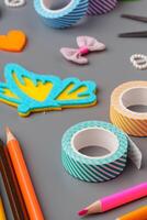 Crafting materials and tools arranged on a gray surface during a creative project photo