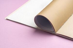 view of notebook with blank pages on a pink background photo