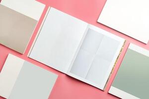 A Collection of Blank Papers Stacked on a Pink Surface for Creative Projects photo