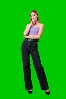 Woman With Long Hair Contemplating While Posing Against a Green Screen photo