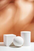White geometric shapes arranged stylishly on a soft peach background in a minimalist setting photo