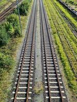 View of the tracks of a freight station with some wagons and numerous sidings. photo