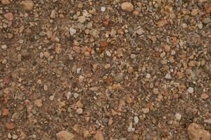 A close up of a gravel surface with many different types of rocks photo