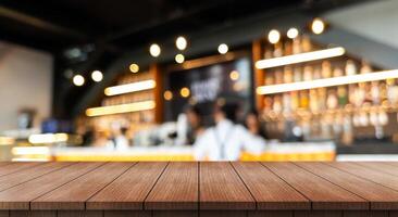 Empty wooden table top with lights bokeh on blur restaurant background. photo