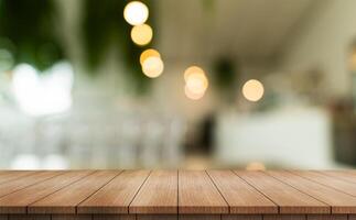 Empty wooden table top with lights bokeh on blur restaurant background. photo