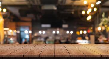 Empty wooden table top with lights bokeh on blur restaurant background. photo