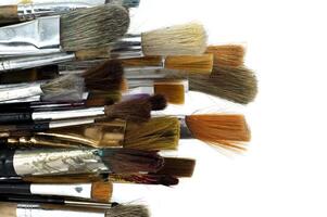 Assortment of various types and sizes of paintbrushes photo
