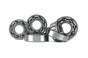 A collection of metal ball bearings in different sizes on a white background photo