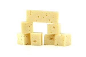 Stack of Swiss cheese cubes isolated on white background photo