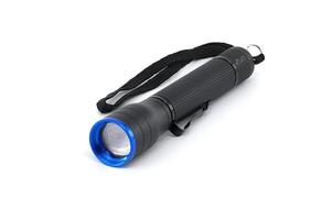 Black flashlight with a blue lens and wrist strap isolated on white background photo