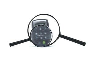 Magnifying glass revealing a calculator keypad, emphasizing focus on finance photo