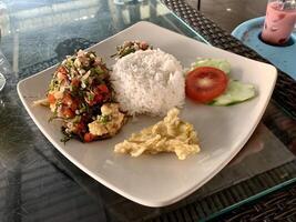 white plate with rice and vegetables on top photo