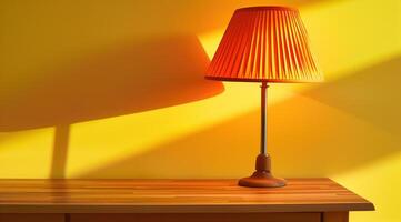 Table lamp with yellow lampshade stands on wooden table. Copyspace. Yellow back photo