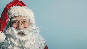 Portrait of Santa Claus on a blue background. Copy space. photo