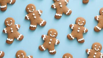 Gingerbread man pattern on blue background, top view. photo