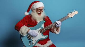 Santa Claus with electric guitar on a blue background. photo