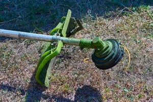 Professional grass cutting on lawns with a mini handle lawn mower photo