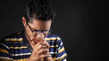 A man with glasses and a striped shirt is praying video