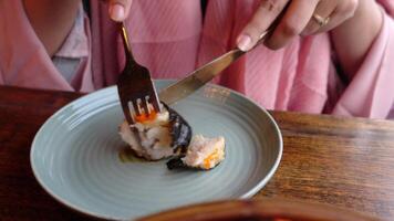 A person holding a fork and knife over a plate of food video
