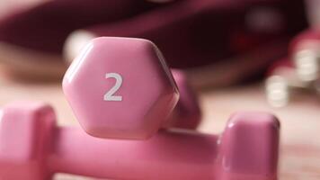 A pink dumbbell with the number two on it video