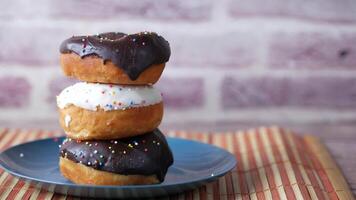 A stack of three donuts on a plate video