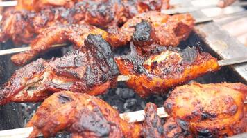 Chicken on skewers being cooked on a grill video