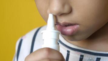 A child is using an inhaler to blow into their nose video