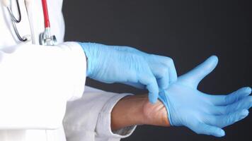 A doctor is putting on a glove video