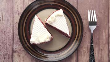 A plate with two pieces of red velvet cake on it video