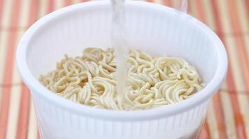 A white container with noodles in it video