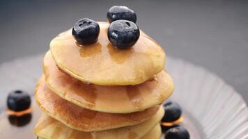 A stack of pancakes with blueberries on top video