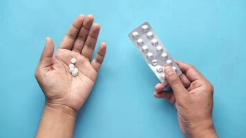 Two hands holding a pill and a pill in their hands video