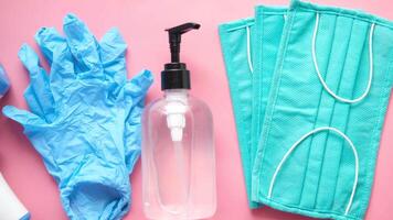 A bottle of hand sanitizer, gloves, and a bottle of disinfectant video