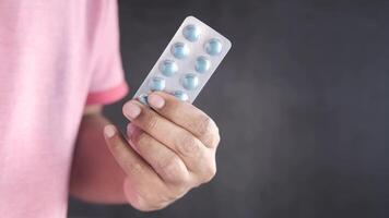 A man holding a tablet with pills in it video