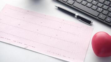 A heart monitor, a pen and a keyboard on a desk video