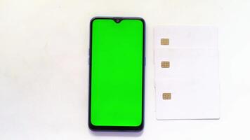 A green sim card and a smartphone with sim card video