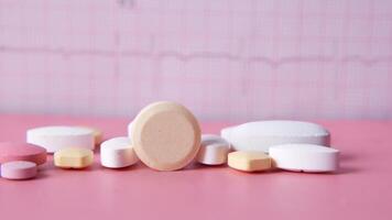 Various pills on a pink background video