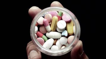 A person holding a container full of pills video