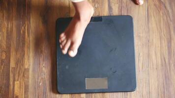 A person standing on a scale with their feet on it video