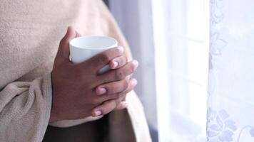A person holding a cup of coffee in their hands video