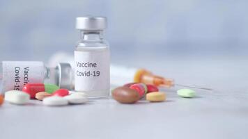 Vaccine and pills on a table video