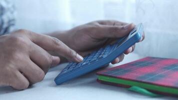 A person using a calculator on a desk video