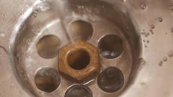 A close up of a drain with water running through it video