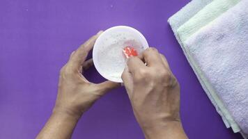 A person is using a sponge to clean a towel video
