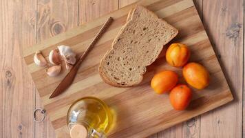 Bread, oranges and garlic on a cutting board video