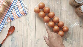 A person pointing at eggs in a plastic container video