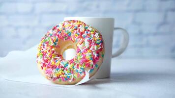 A cup of coffee and a donut on a table video