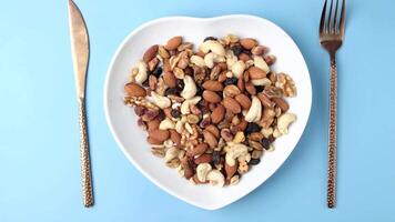 Nuts and nuts on a white plate with a fork and knife video